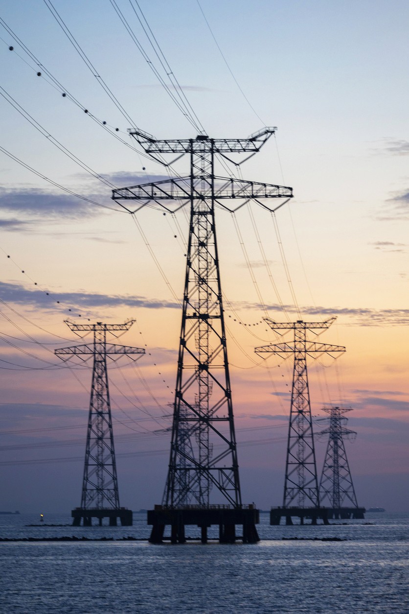 Power lines stretching across a large body of water